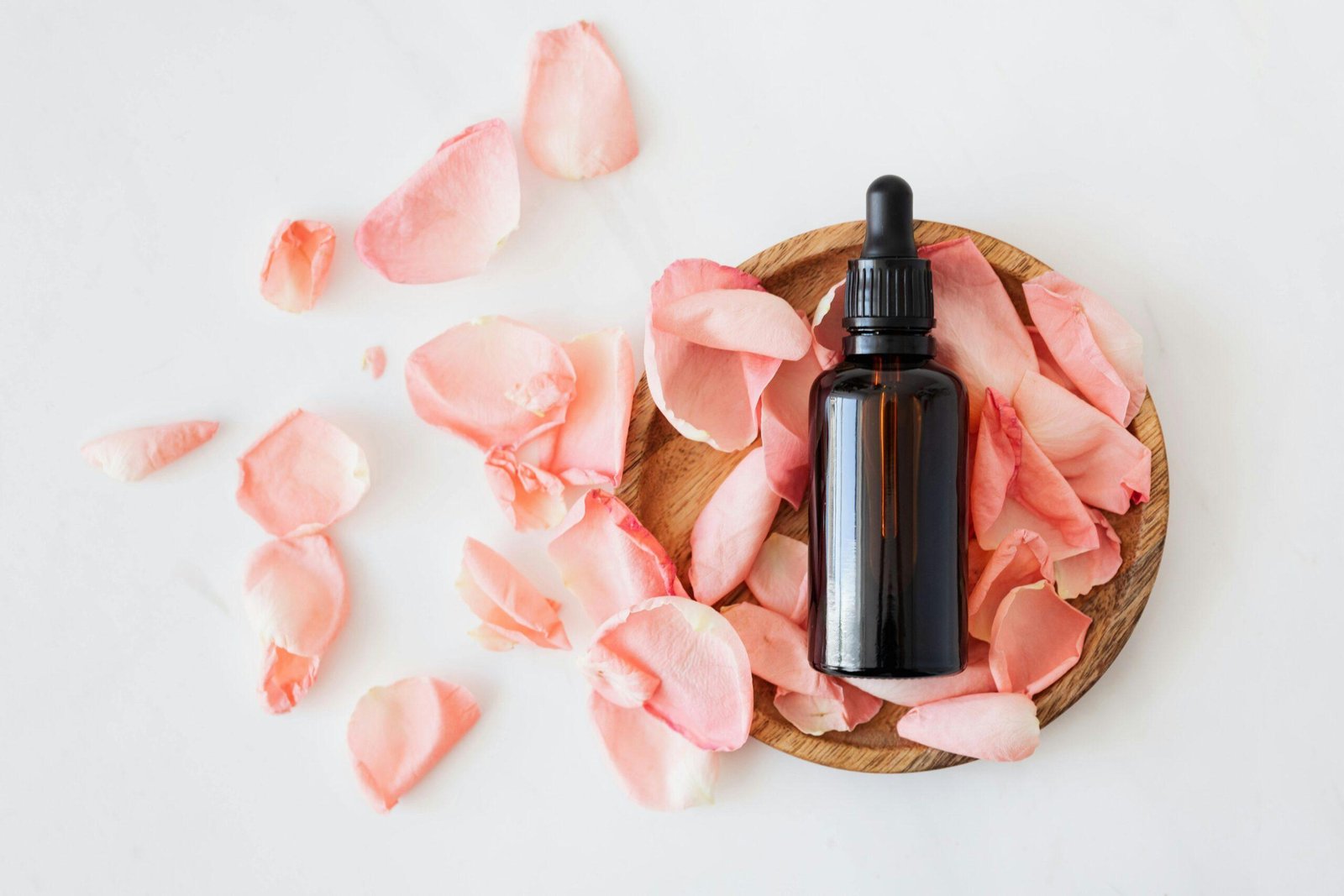 Dropper Bottle of Organic Rosehip Oil with Fresh Rose Petals