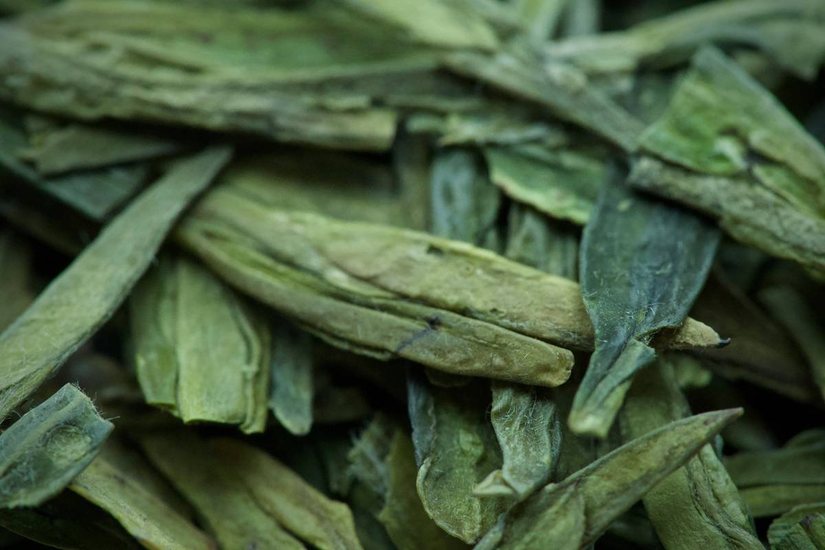 A woman smiling with glowing, hydrated skin after using organic oils infused with herbal essence extracts