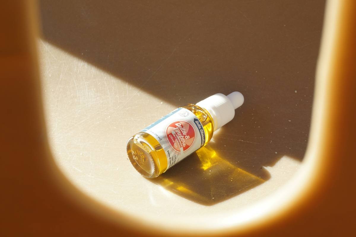 Close-up photo demonstrating how to apply hemp skin oil to targeted areas using fingertips.