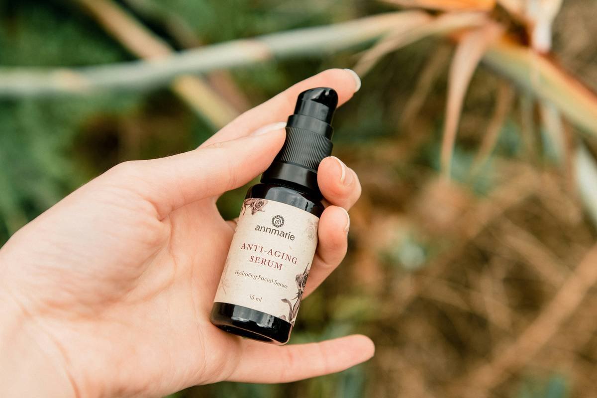 Bottle of organic pumpkin face oil on a wooden counter