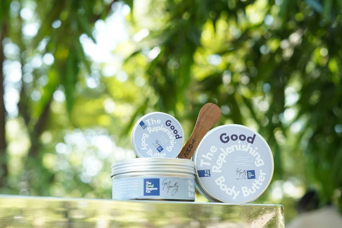 Lavender plants, essential oil bottles, and dropper against a white background.